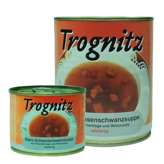 Trognitz Klare Ochsenschwanzsuppe - 1 kleine und 1 große Konservendose mit rotem Etikett und Suppe als Motiv. 
